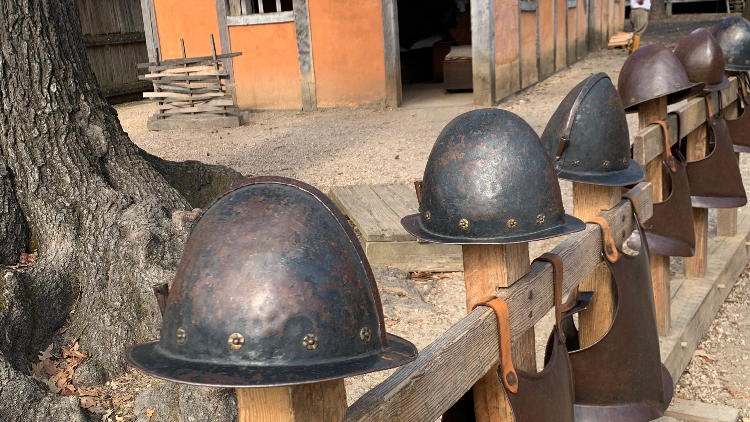 Feature image: Armor helmets and breastplates handing on a fence